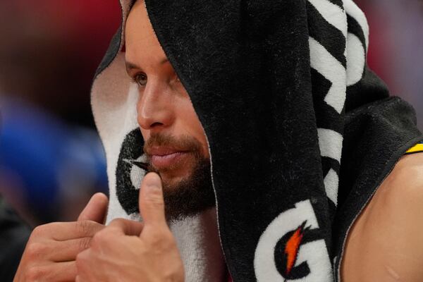 Golden State Warriors guard Stephen Curry watches from the bench during the second half of Game 5 of an NBA basketball first-round playoff series against the Houston Rockets, Wednesday, April 30, 2025, in Houston. (AP Photo/David J. Phillip)