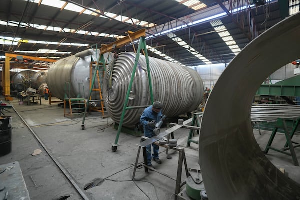 An employee works at a steel tank factory in Mexico City, Tuesday, Feb. 11, 2025. (AP Photo/Eduardo Verdugo)