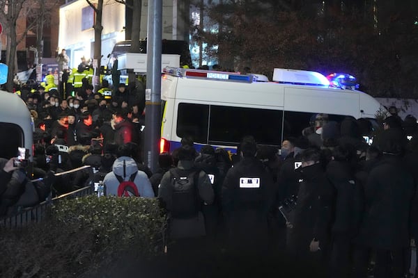 Police officers gather outside of the gate of the presidential residence in Seoul, South Korea, Wednesday, Jan. 15, 2025. (AP Photo/Lee Jin-man)