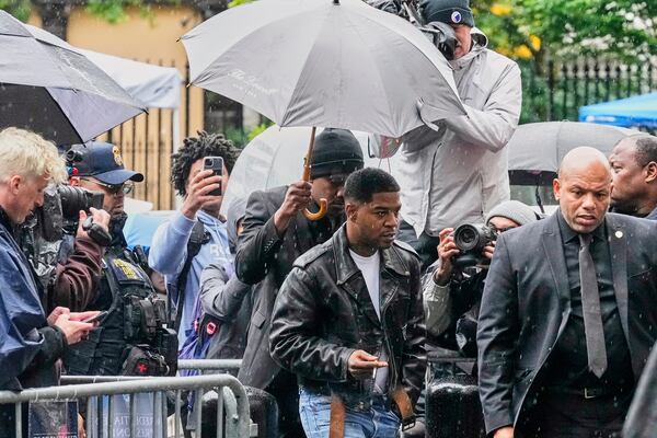 Rapper Kid Cudi, center, arrives at Federal Court for the trial of Sean "Diddy" Combs, in New York, Thursday, May 22, 2025. (AP Photo/Richard Drew)