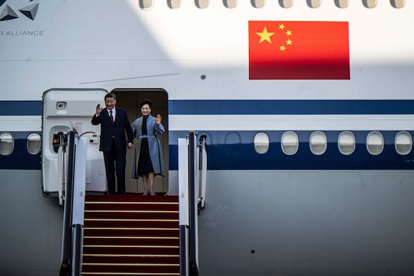 China's President Xi Jinping and his wife Peng Liyuan wave as they arrive at the airport in Macao, China, Wednesday, Dec. 18, 2024, ahead of celebrations marking the 25th anniversary of the casino city’s return to Chinese rule. (Eduardo Leal/Pool Photo via AP)