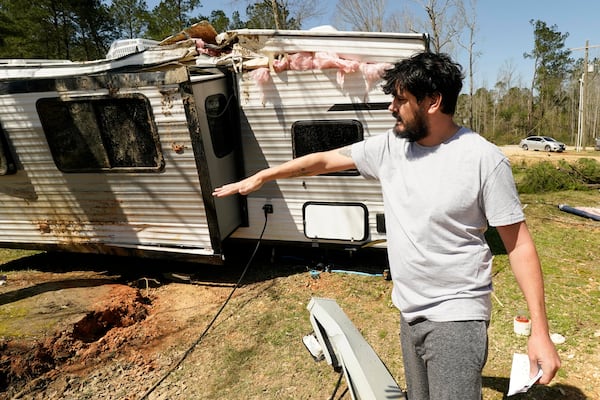 Cody McCoy of Biloxi, Miss., recalls the escape he and his family undertook, when Saturday's tornado flipped their bunkhouse camper in Tylertown, Miss., on Sunday, March 16, 2025. (AP Photo/Rogelio V. Solis)