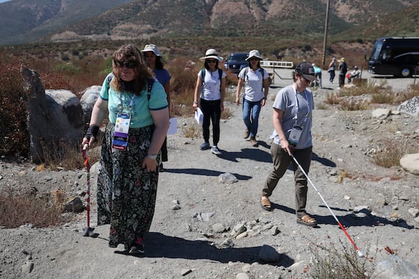 Attendees walk during an accessible field trip to the San Andreas Fault organized by the International Association of Geoscience Diversity Thursday, Sept. 26, 2024, in San Bernadino, Calif. (AP Photo/Ryan Sun)