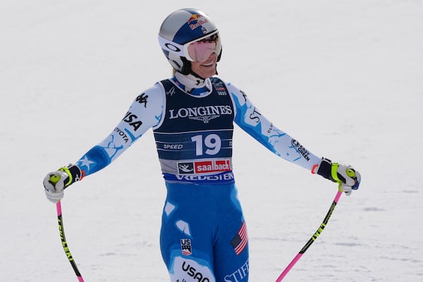 United States' Lindsey Vonn smiles at the finish area of a downhill run of a women's team combined event, at the Alpine Ski World Championships, in Saalbach-Hinterglemm, Austria, Tuesday, Feb. 11, 2025. (AP Photo/Giovanni Auletta)