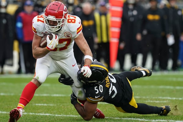 Pittsburgh Steelers linebacker Elandon Roberts (50) tackles Kansas City Chiefs tight end Travis Kelce (87) during the second half of an NFL football game, Wednesday, Dec. 25, 2024, in Pittsburgh. (AP Photo/Matt Freed)