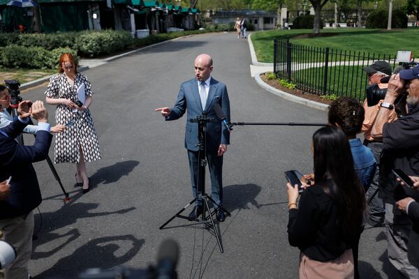 White House deputy chief of policy Stephen Miller speaks with reporters at the White House, Friday, April 18, 2025, in Washington. (AP Photo/Tom Brenner)