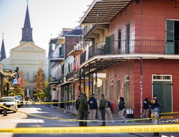 The FBI investigates the area on Orleans St and Bourbon Street by St. Louis Cathedral in the French Quarter where a suspicious package was detonated after a person drove a truck into a crowd earlier on Bourbon Street on Wednesday, Jan. 1, 2025. (AP Photo/Matthew Hinton)