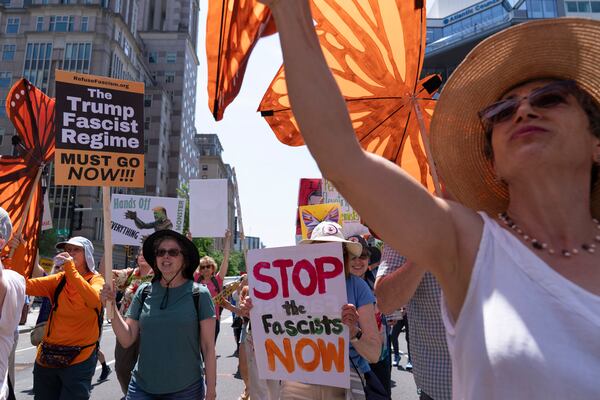Demonstrators march to the White House during a May Day protest in Washington, Thursday, May 1, 2025. (AP Photo/Jose Luis Magana)