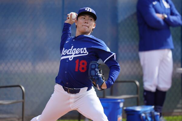 Los Angeles Dodgers pitcher Yoshinobu Yamamoto, of Japan, throws during a pitching session at the Dodgers baseball spring training facility, Tuesday, Feb. 11, 2025, in Phoenix. (AP Photo/Ross D. Franklin)