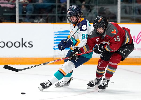 FILE - New York Sirens' Micah Zandee-Hart (28) keeps Ottawa Charge's Brianne Jenner (19) from the puck during first period PWHL hockey action in Ottawa, on Wednesday, Feb. 26, 2025. (Justin Tang/The Canadian Press via AP, File)