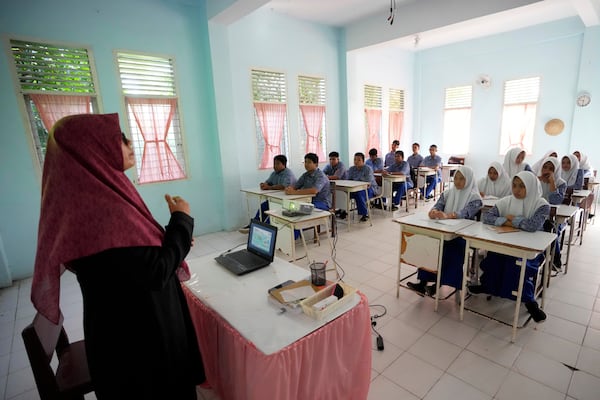 Students attend a class at a school in Banda Aceh, Indonesia, Thursday, Dec. 12, 2024. (AP Photo/Achmad Ibrahim)