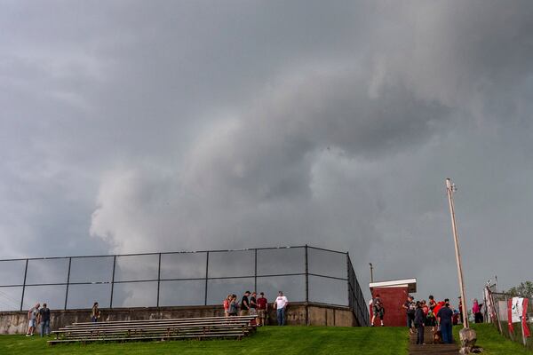 Fans head up the hill to the parking lots when the game was stopped between California and Fort Cherry High School baseball teams at Fort Cherry High School in McDonald, Pa., Tuesday, April 29, 2025. (Lucy Schaly/Pittsburgh Post-Gazette via AP)