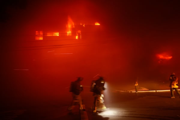 Firefighters battle the Palisades Fire in the Pacific Palisades neighborhood of Los Angeles, Tuesday, Jan. 7, 2025. (AP Photo/Etienne Laurent)