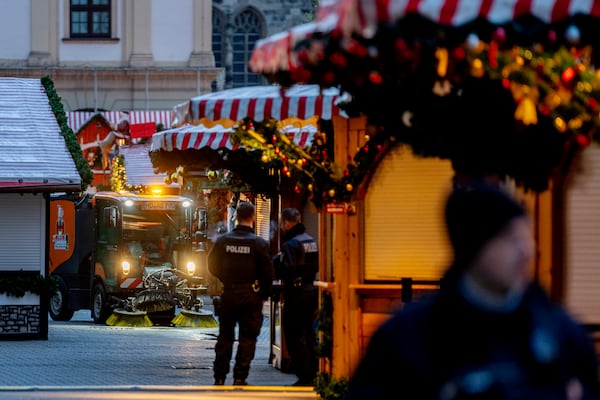 Public workers clean the Christmas Market, where a car drove into a crowd on Friday evening, in Magdeburg, Germany, is empty on Sunday morning , Dec. 22, 2024. (AP Photo/Michael Probst)