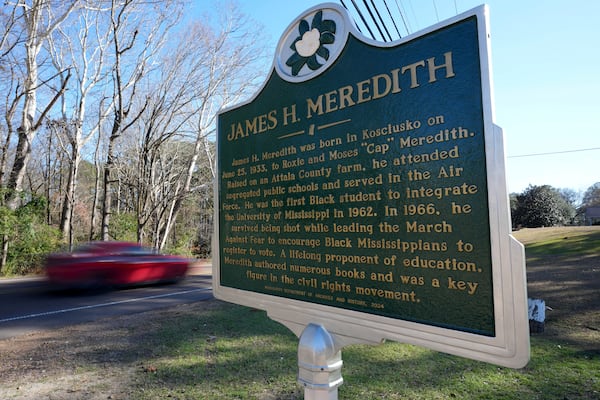 A car speeds past a Mississippi Department of Archives and History marker recognizing the birthplace and legacy of James Meredith in the Civil Rights Movement, in Kosciusko, Miss., Friday, Dec. 20, 2024. Meredith, was the first Black student to enroll at the University of Mississippi in 1962. (AP Photo/Rogelio V. Solis)