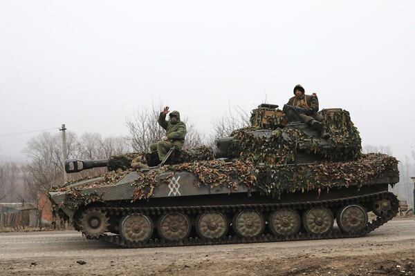 In this photo taken from video distributed by Russian Defense Ministry Press Service on Friday, March 14, 2025, Russian soldiers ride atop of self-propelled gun at an area in the Kursk region of Russia after it was taken over by Russian troops. (Russian Defense Ministry Press Service via AP)