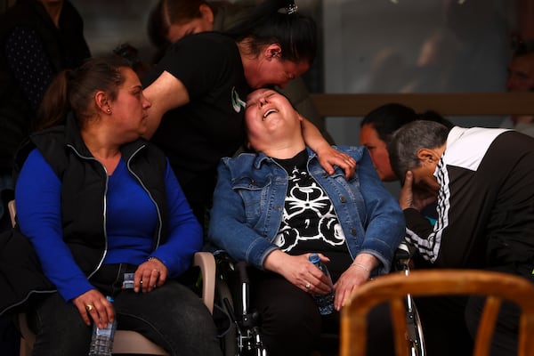 Women cry outside a hospital in the town of Kocani, North Macedonia, Sunday, March 16, 2025, following a massive fire in the nightclub early Sunday. (AP Photo/Armin Durgut)