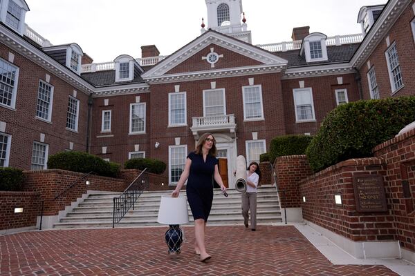 U.S.-Rep.-elect Sarah McBride, D-Del., left, and her incoming Deputy Chief of Staff & Communications Director, Michaela Kurinsky-Malos, move out of McBride's Delaware State Senate office at the Delaware Legislative Hall in Dover, Del., Tuesday, Dec. 17, 2024. (AP Photo/Carolyn Kaster)