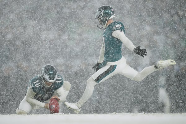 Philadelphia Eagles' Jake Elliott, right, kicks a field goal during the second half of an NFL football NFC divisional playoff game against the Los Angeles Rams on Sunday, Jan. 19, 2025, in Philadelphia. (AP Photo/Derik Hamilton)