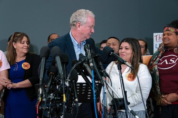 Sen. Chris Van Hollen, D-Md., gives a hug to Jennifer Vasquez Sura, the wife of Kilmar Abrego Garcia, as he speaks during a news conference upon his arrival from meeting with Abrego Garcia in El Salvador, at Washington Dulles International Airport, in Chantilly, Va., Friday, April 18, 2025. (AP Photo/Jose Luis Magana)