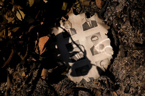 A partially burned yearbook is seen on the ground in the aftermath of the Palisades Fire in the Pacific Palisades neighborhood of Los Angeles, Monday, Jan. 13, 2025. (AP Photo/John Locher)