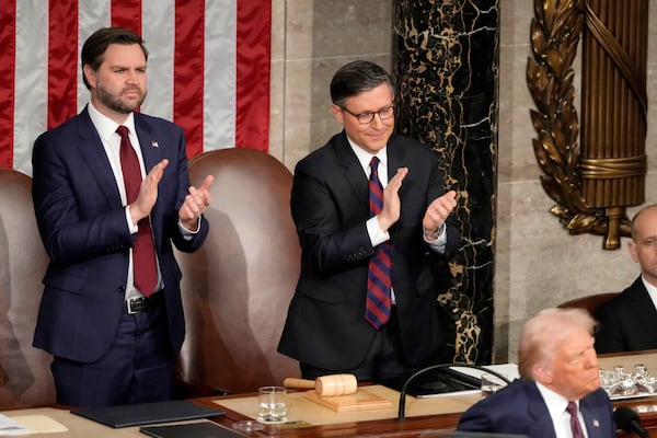 Vice President JD Vance, from left, and House Speaker Mike Johnson, R-La., clap as President Donald Trump addresses a joint session of Congress at the Capitol in Washington, Tuesday, March 4, 2025. (AP Photo/Ben Curtis)