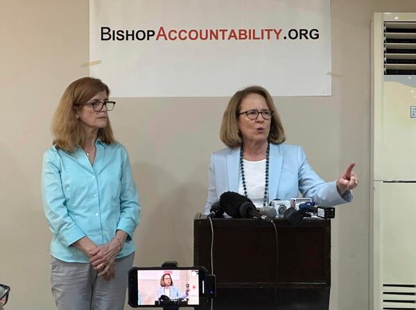 Anne Barrett Doyle, right, Co-Director and Suzy Nauman, database manager of BishopAccountability.org, a United States-based watchdog, speaks at a news conference in Manila on Jan.29, 2025 where they launched an online database on more than 80 Roman Catholic priests who have been accused of sexually abusing minors in the Philippines. (AP Photo/Joeal Calupitan)