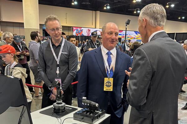 FILE - Berkshire Hathaway Vice Chairman Greg Abel checks out the flight simulators offered by one of Berkshires companies, Flight Safety as he toured the exhibit hall Friday, May 3, 2024, in Omaha, Neb. ahead of Saturday's meeting. (AP Photo/Josh Funk, File)