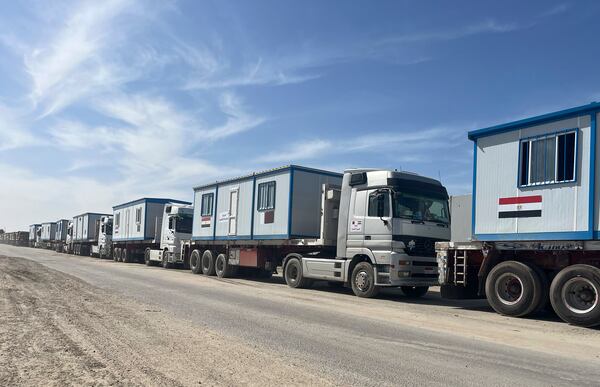 Scores of trucks carrying mobile homes line up on the Egyptian side of the Rafah crossing in preparation for entering Gaza, at the Rafah border crossing, Egypt, Tuesday, Feb. 18, 2025. (AP Photo/Mayar Mokhtar)