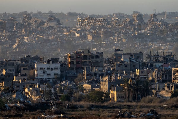 Destroyed buildings stand inside the Gaza Strip, as seen from southern Israel, Tuesday, Jan. 7, 2025. (AP Photo/Ariel Schalit)