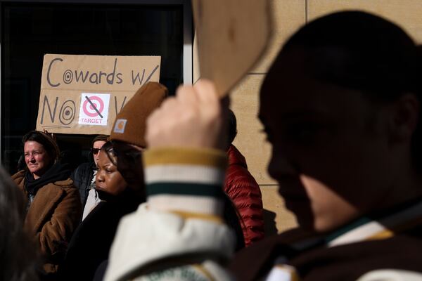 Community members listen during a news conference organized by Black Lives Matter Minnesota outside Target Corporation's headquarters Thursday, Jan. 30, 2025, in Minneapolis, Minn. (AP Photo/Ellen Schmidt)