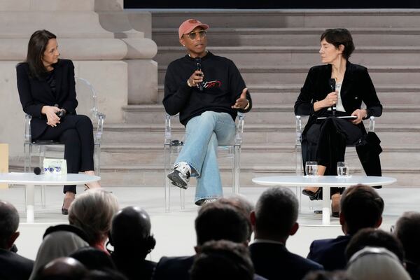 Musician and fashion designer Pharrell Williams, center, speaks on a panel at the Grand Palais during the Artificial Intelligence Action Summit in Paris, Tuesday, Feb. 11, 2025. (AP Photo/Michel Euler)