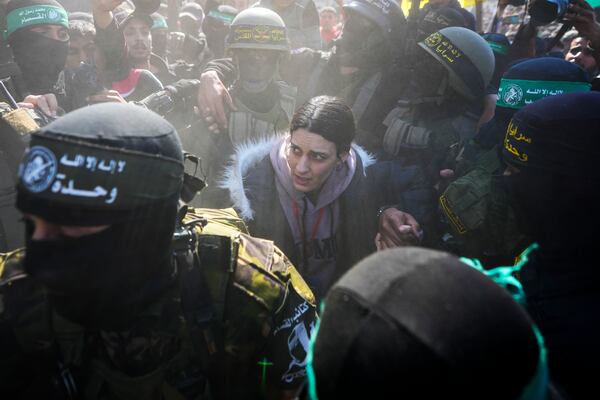 Israeli Arbel Yehoud, 29, who had been held hostage by Hamas in Gaza since Oct. 7, 2023, is escorted by Hamas and Islamic Jihad fighters as she is handed over to the Red Cross in Khan Younis, southern Gaza Strip, Thursday Jan. 30, 2025. (AP Photo/Abdel Kareem Hana)