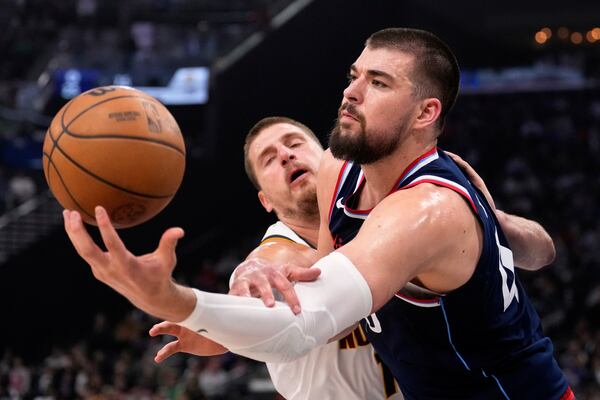 Denver Nuggets center Nikola Jokic, left, and Los Angeles Clippers center Ivica Zubac reach for a rebound during the first half in Game 6 of an NBA basketball first-round playoff series Thursday, May 1, 2025, in Inglewood, Calif. (AP Photo/Mark J. Terrill)