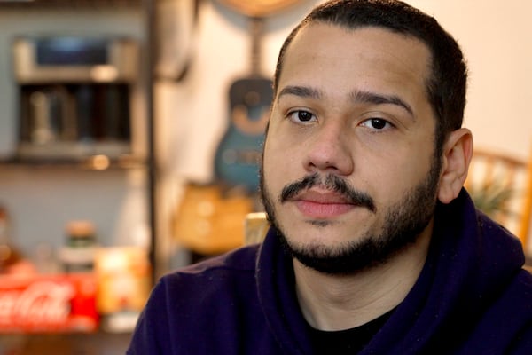 Johann Teran, a Venezuelan in the United States on humanitarian parole, speaks about the new uncertainties for migrants since the Trump administration has canceled humanitarian protections, at his mother-in-law's home in Hopkins, Minn., on Thursday, Feb. 13, 2025. (AP Photo/Mark Vancleave)