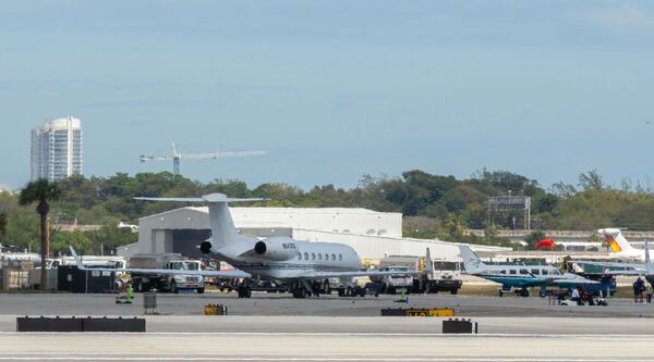 The plane carrying influencer brothers Andrew and Tristan Tate have arrives in Fort Lauderdale, Fla. from Romania on Thursday, Feb. 27, 2025. (AP Photo/Jennifer Lett)