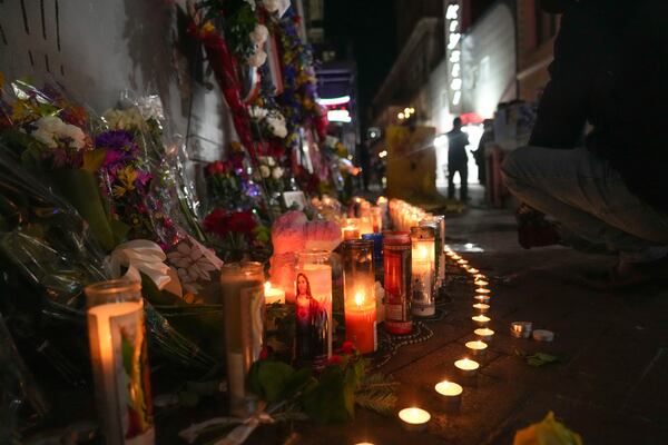 Flowers and votive candles line a memorial for the victims of a deadly truck attack on New Year's Day in New Orleans, Friday, Jan. 3, 2025. (AP Photo/Gerald Herbert)