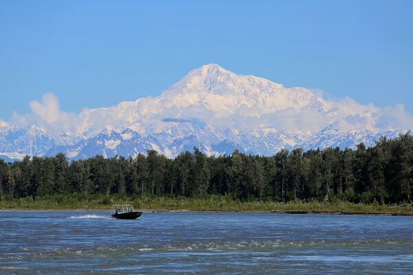 FILE - A boat is seen on the Susitna River near Talkeetna, Alaska, on Sunday, June 13, 2021, with Denali in the background. Denali, the tallest mountain on the North American continent, is located about 60 miles northwest of Talkeetna. (AP Photo/Mark Thiessen, File)