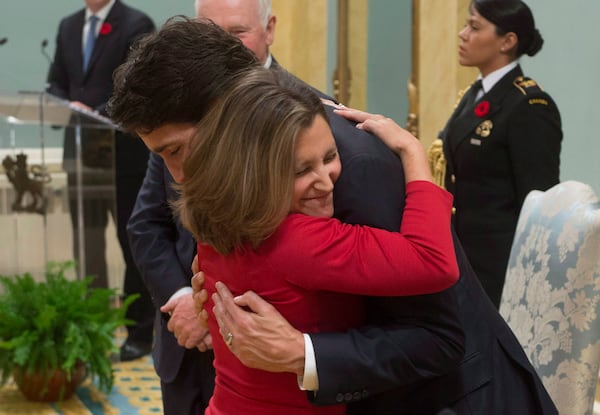 FILE - Minister of International Trade Chrystia Freeland gives Prime Minister Justin Trudeau a hug after being sworn in during ceremonies at Rideau Hall, on Nov. 4, 2015, in Ottawa. (Adrian Wyld/The Canadian Press via AP, File)