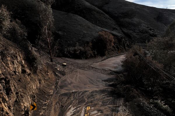 Mud covers Topanga Canyon Rd. on the Palisades Fire burn area after a series of weekend storms Monday, Jan. 27, 2025 near Malibu, Calif. (AP Photo/Jae C. Hong)