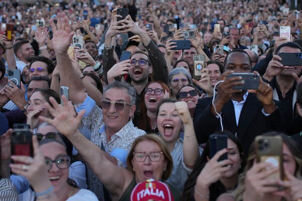 People react as the newly elected Pope Leo XIV appears on the balcony of St. Peter's Basilica at the Vatican, Thursday, May 8, 2025. (AP Photo/Emilio Morenatti)