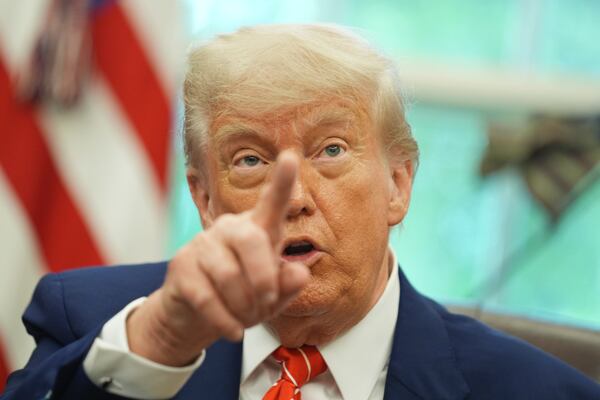President Donald Trump gestures as he speaks with reporters after announcing a trade deal with United Kingdom in the Oval Office of the White House, Thursday, May 8, 2025, in Washington. (AP Photo/Evan Vucci)