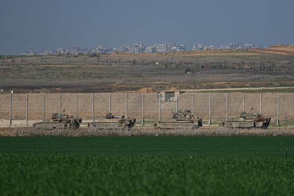 Israeli army APCs are moving along the border with the Gaza Strip in southern Israel on Thursday, Jan. 16, 2025. (AP Photo/Tsafrir Abayov)