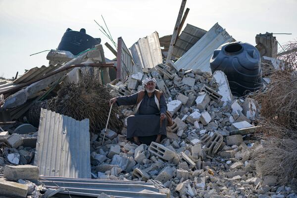 Atiya Abu Sheiban sits on the ruins of his destroyed home, days after the ceasefire deal between Israel and Hamas, in Rafah, southern Gaza Strip, Tuesday, Jan. 21, 2025. (AP Photo/Abdel Kareem Hana)