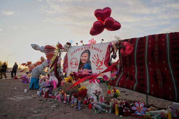 A tribute to slain Native American teen Emily Pike adorns a fence at a vigil in her honor in Mesa, Ariz., Thursday, March 6, 2025. (AP Photo/Samantha Chow)