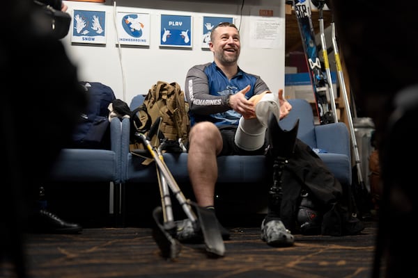 Oleksandr Shvachka prepares to put on a prosthetic leg after a lesson with Oregon Adaptive Sports on the three track skiing method at Hoodoo Ski Area in central Oregon on Thursday, March 6, 2025. (AP Photo/Jenny Kane)