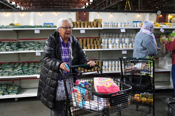 Alameda resident Beatriz Cortez picks up groceries at the Alameda Food Bank on Friday, April 25, 2025. (AP Photo/Terry Chea)