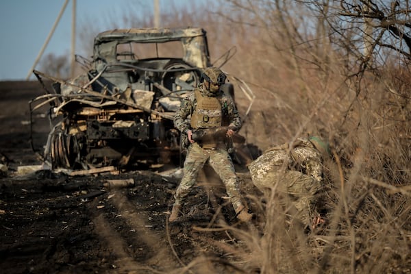 Ukrainian servicemen collect damaged ammunition on the road at the front line near Chasiv Yar town, in Donetsk region, Ukraine, Ukraine, Friday, Jan. 10, 2025. (Oleg Petrasiuk/Ukraine's 24th Mechanised Brigade via AP)