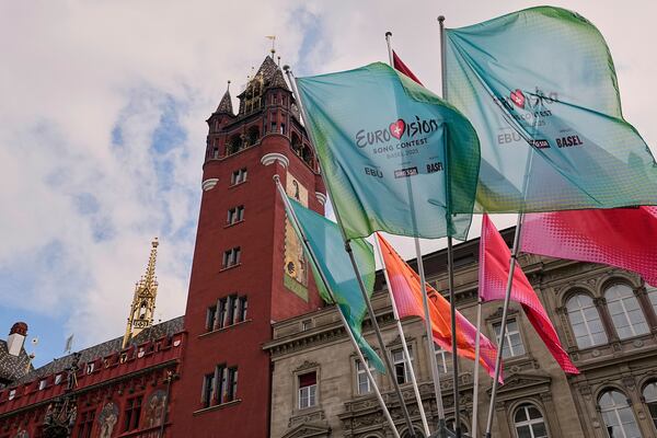 Eurovision flags wave in front of the 500-year-old Basel Town Hall in the city center ahead of the first semi-final of the 69th Eurovision Song Contest, in Basel, Switzerland, Tuesday, May 13, 2025. (AP Photo/Martin Meissner)