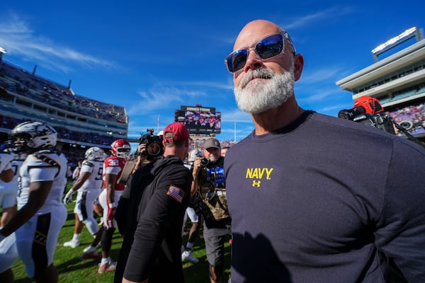 Navy head coach Brian Newberry walks on the field after shaking hands with Oklahoma head coach Brent Venables following the Armed Forces Bowl NCAA college football game, Friday, Dec. 27, 2024, in Fort Worth, Texas. Navy won 21-20. (AP Photo/Julio Cortez)